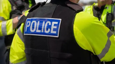 Trio of police officers on duty - stock photo