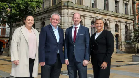 DfC Pictured (L-R) outside the former Danske Bank building in Londonderry are Shona Campbell, General Manager Inner City Trust; Damian McAteer, Inner City Trust; Communities Minister Gordon Lyons MLA and Vicki Hassan, Operations Director at Danske Bank