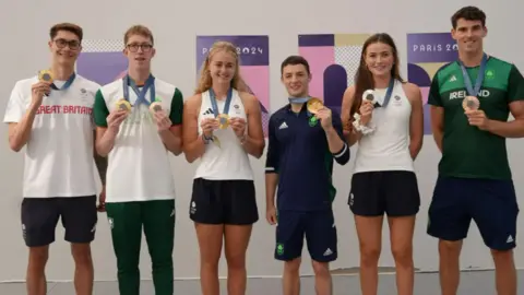 Olympic athletes from Northern Ireland lined up with their medals 