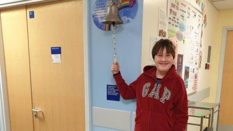 Henry ringing the cancer bell at the end of treatment