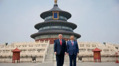 U.S. President Donald Trump and Chinese President Xi Jinping stand together as they tour the Temple of Heaven in Beijing, China, May 14, 2026