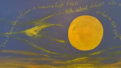 Betsy Smith Painting of a yellow moon with blue background. There are words on the painting in yellow lettering including The Moon like a flower in heavens high