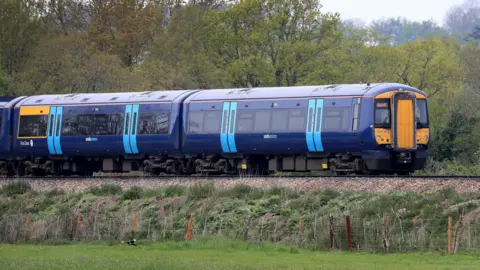 A blue Southeastern train passes through Kent.