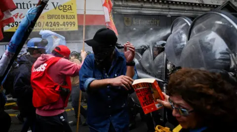 Reuters Police spray demonstrators during a protest near the National Congress