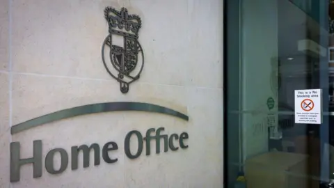 In pictures via Getty Images The Home Office sign outside the department building in Whitehall