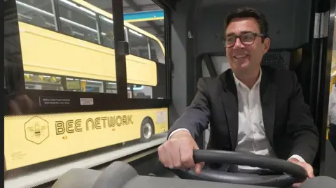 PA Media Bee Network bus and Andy Burnham