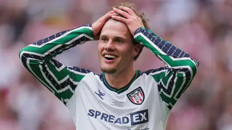 Leo Hjelde with both hands on his head and his face a picture of amazement after Sunderland beat Sheffield United to win the Championship play-off final