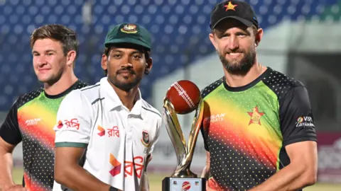 Bangladesh captain Nazmul Hossain Shanto and Zimbabwe skipper Craig Ervine with the Test series trophy after the series was shared