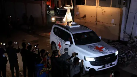 Reuters Red Cross vehicles transport the bodies of deceased hostages who had been held in Gaza 