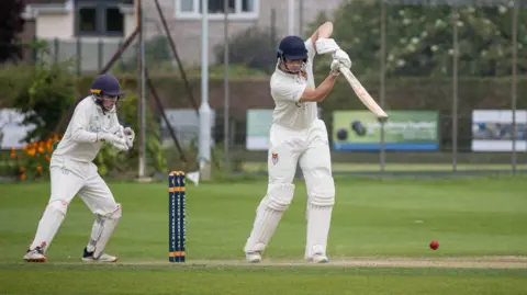 Evan Hill Wicketkeeper watching batsman play shot