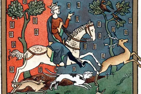 Getty Images Medieval manuscript illustration of a king riding through a forest while hunting a stag