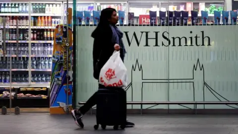 EPA A Passenger passes a WHSMITH store on 25 January 2025 in London, Britain. British retailer WHSMITH said she is searching for options to sell its entire high street business. WHSMITH has more than five hundred stores across the UK and employs a few thousand people.