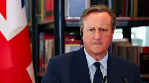 David Cameron with an earpiece in 