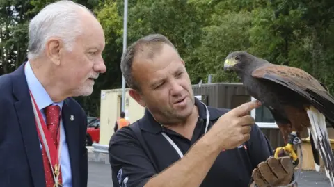 KCC Willow the hawk with falconer Dave Mewburn and council chairman Bryan Sweetland
