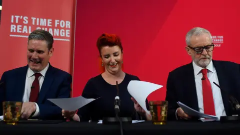 Getty Images Louise Haigh pictured alongside Keir Starmer and Jeremy Corbyn behind a banner saying "It's time for real change"