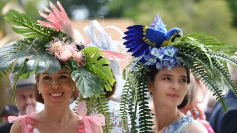 Reuters Racegoers wearing bird themed hats arrive ahead of the day's races.