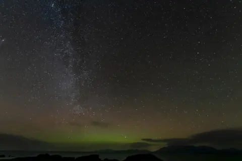 Steven Gray/Cosmos Planetarium A starry night sky and aurora borealis