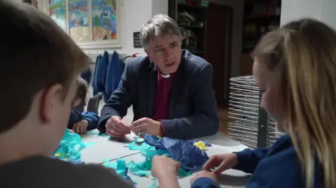 BBC Bishop Hugh Nelson with two children 