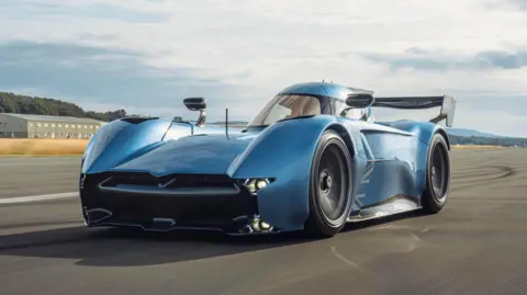 PA Media A light blue McMurtry Speirling Pure VP1 track car. It is a single seater with a large spoiler at the back 