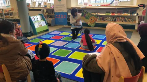 Aisha Iqbal/BBC Children listening to a storytime session at Keighley Library.