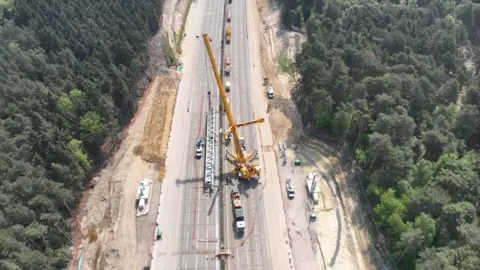 National Highways An aerial behold of a crane on the M25