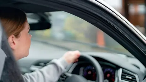 Driver behind the wheel of a car
