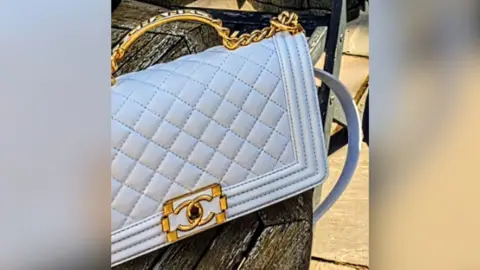 Nottinghamshire Police Snapshot of a white Chanel handbag which has a gold handle and lock