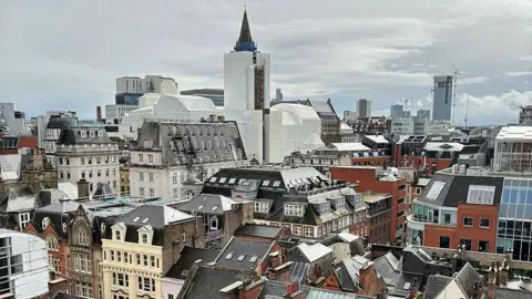 DavidDixon/Geograph A view from the top of St Ann's church tower, looking south-eastwards over the city centre rooftops, towards Manchester Town Hall.