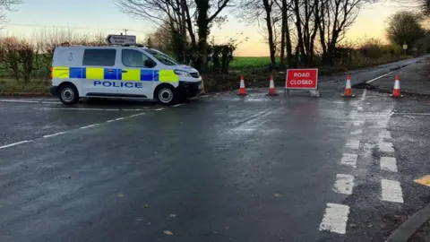BBC/Seb Cheer The junction of Rudgate and Toulston Lane, with a police van guarding the scene.