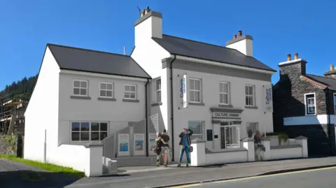 An illustration of the redeveloped Fairfield House, which is white and has Culture Vannin written above the door. 