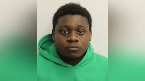 Met Police A custody image of Barthimaus Ehiemere in a green hoodie.