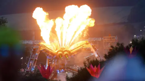 Fire coming out large spider sculpture at Arcadia at Glastonbury
