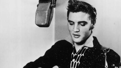 Elvis Presley singing into a microphone