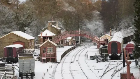 PA Media Snow-covered rail tracks and platforms at Goathland Station on the North Yorkshire Moors Railway.