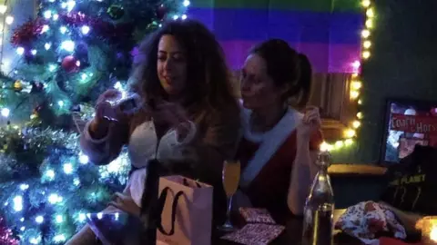 Hannah Williams Hannah and another employee exchanging gifts