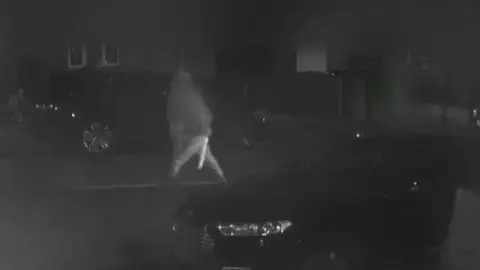 Avon and Somerset Police A blurry CCTV image shows one of the teenagers carrying a weapon