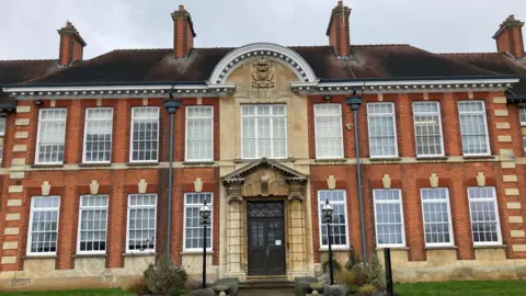 Exterior of two-storey red brick comprehensive school.