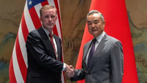 Chinese foreign minister Wang Yi shakes hands with White House National Security Adviser Jake Sullivan