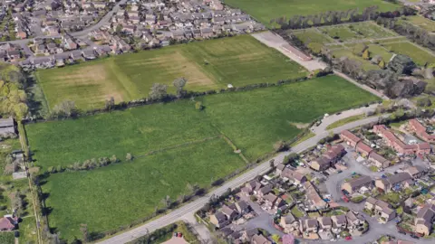 Google An aerial view of a field next to three rugby pitches.