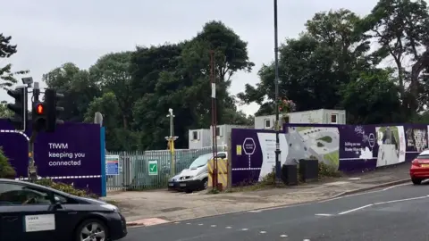 LDRS Construction taking place at a railway station - the outside of the station pictured with a purple sign with the words TFWM keeping you connected