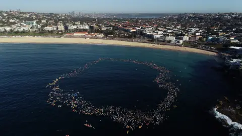 Paddle out at Bondi, ring-shaped in the ocean