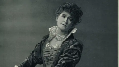 Coventry University A portrait of Ellen Terry. A Victorian woman in cultural dress sits in a room.