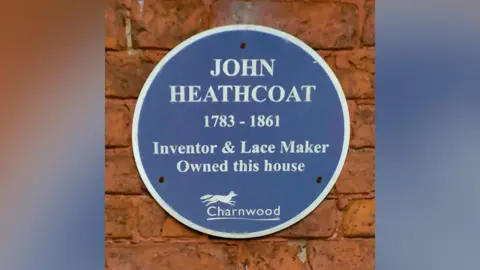 John Harrison/Flickr A blue plaque on the building which reads "John Heathcoat 1783-1861 Inventor & Lace Maker Owned this house" and the insignia of Charnwood Borough Council