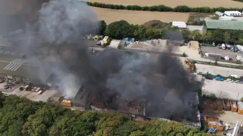 Eddie Mitchell Smoke billowing from a fire at a waste services plant in Climping