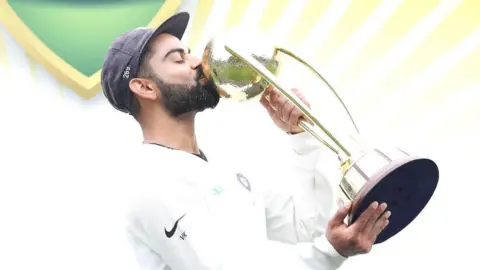Getty Images Virat Kohli of India kisses the Border–Gavaskar Trophy as he celebrates India's 2-1 series win after day five of the Fourth Test match in the series between Australia and India at Sydney Cricket Ground on January 07, 2019 in Sydney, Australia. 
