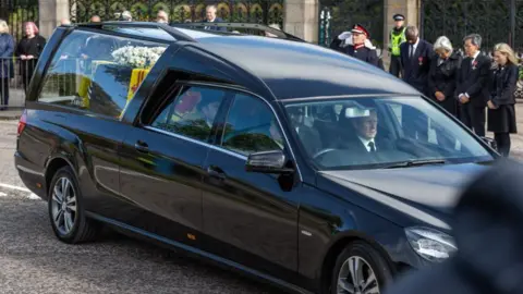 Family delighted by King's praise for toy car at Sandringham - BBC