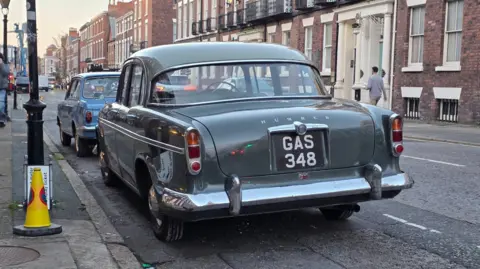 Cara D Photography A dark green retro car with the registration GAS 348 is parked on Rodney Street in Liverpool