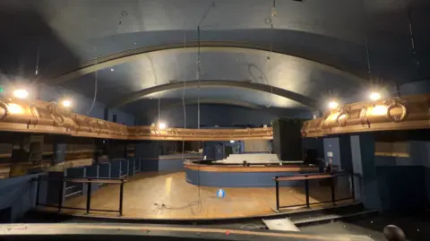 A stripped out nightclub, showing a raised dance area