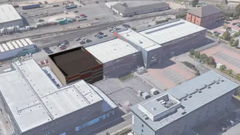 An artist's impression of several large buildings taken from above with sports facilities and car parks in the middle.