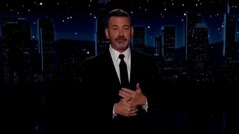 Jimmy Kimmel is talking to the audience during his show.